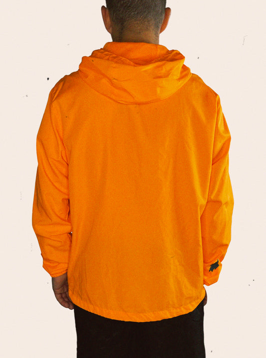 Hunter orange Independent Trading Company hooded windbreaker embellished with a treeline wolf logo on the sleeve